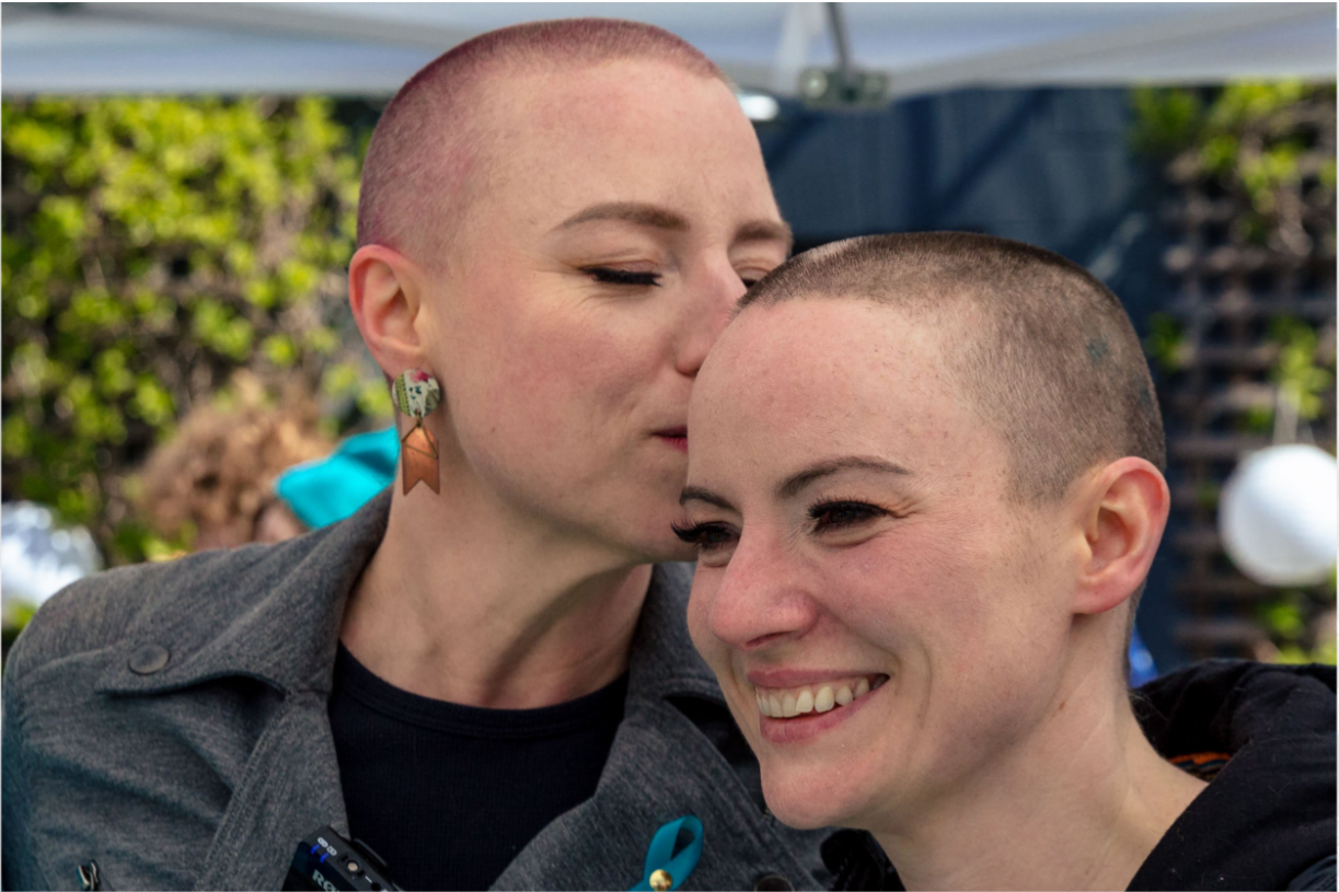Ann kissing her sister’s head – both have just shaved their heads