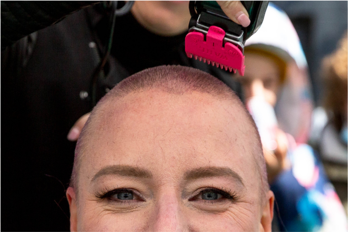 a close up shot of Ann getting her head shaved