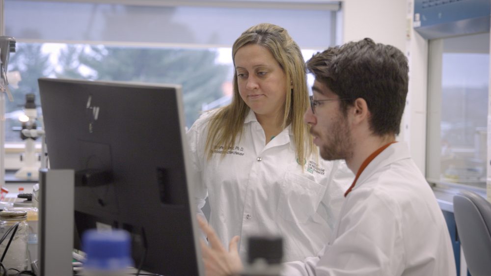 Image of two people working in a laboratory with lab coats